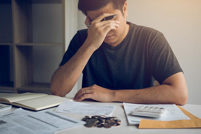 man stressed about financial problems needing stress management system as help
