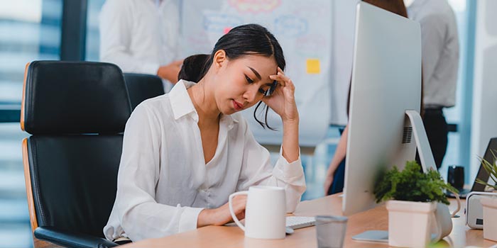 Joven empresaria que se siente estresada en el trabajo que necesita alivio del estrés en el lugar de trabajo